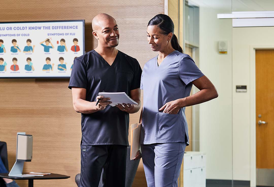 man and woman in scrubs