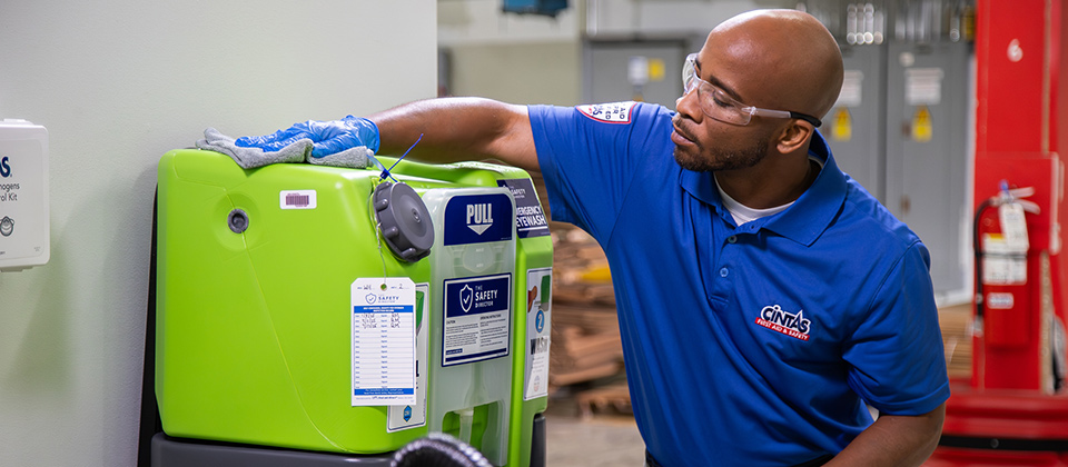 Cintas WORKER CHECKING EYEWASH MACHINE